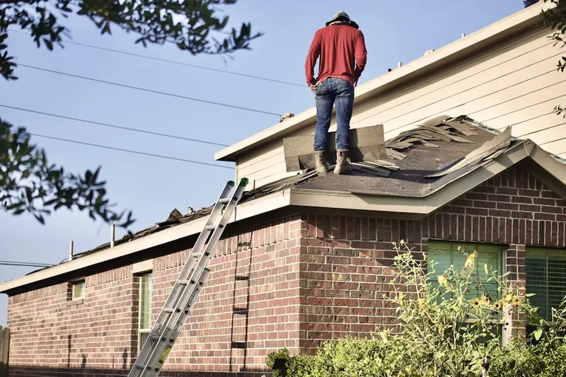 Professional roofer working on a residential roof in Southwest Hoboken